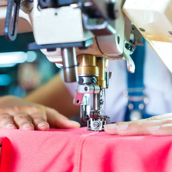 Close view of fabric passing through a sewing machine